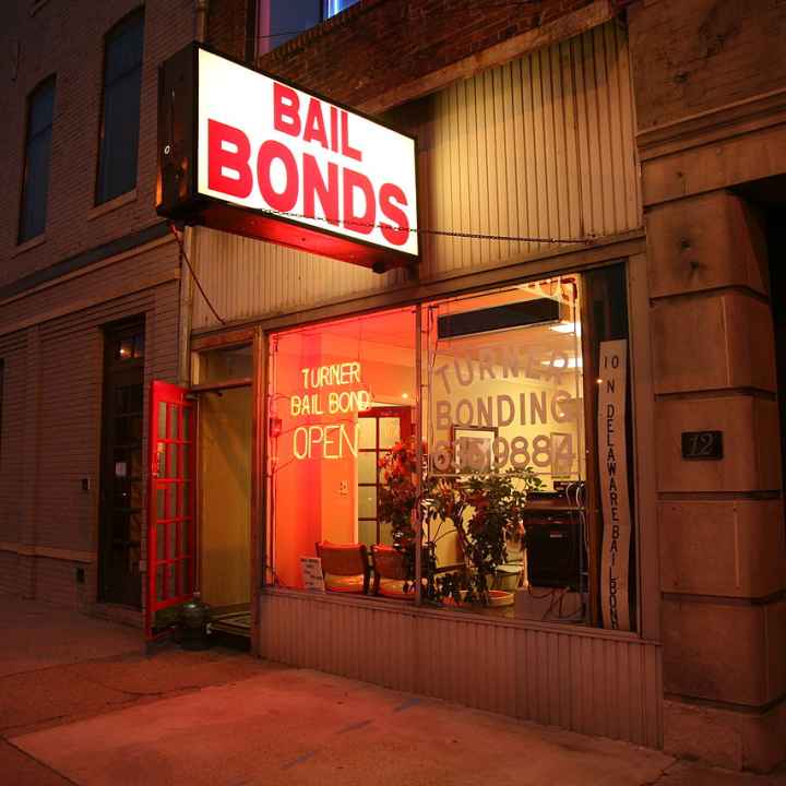 Photo of the outside of a bail bond office at night time 